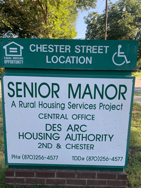 Des Arc apartment for rent - a sign for the senior manor housing services project on the side of the street