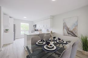 Oshawa apartment for rent - A modern dining room with a glass table and grey chairs.