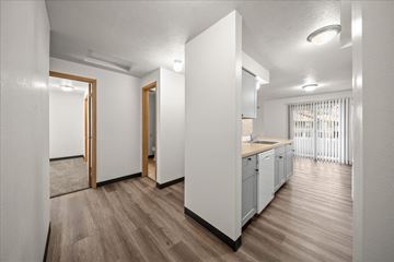 Spokane apartment for rent - A kitchen with white cabinets and a wooden floor.