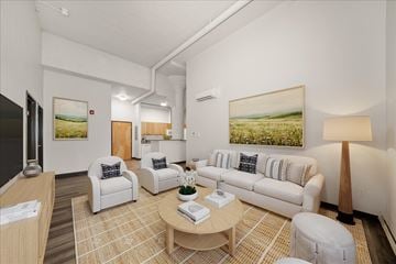 Spokane apartment for rent - A living room with a white couch and a painting of a field on the wall.