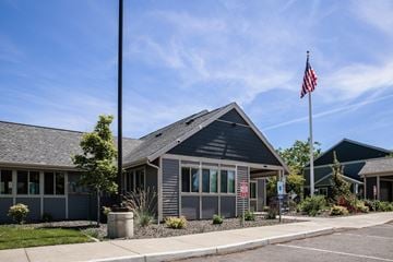 Spokane apartment for rent - A grey building with a flag on top of it.