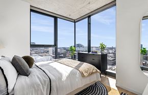 Chicago apartment for rent - a bedroom with a bed and a view of the city