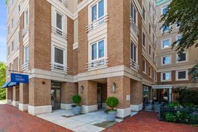 Cambridge apartment for rent - The front of a brick building with a blue sign that says "Bellagio".
