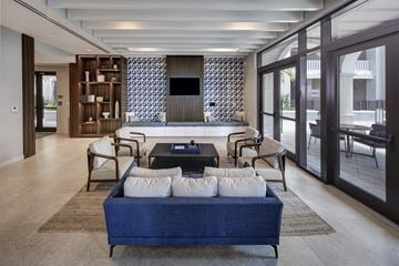 Coral Gables apartment for rent - a living room with a blue couch and a coffee table