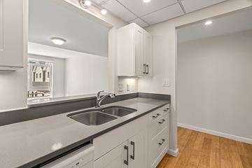 Cambridge apartment for rent - A modern kitchen with a stainless steel sink and white cabinets.