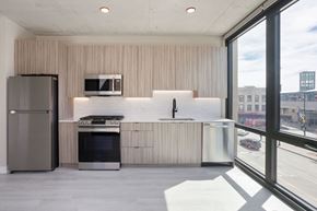 Chicago apartment for rent - a kitchen with a refrigerator freezer and a stove top oven at Platform 4611, Chicago, IL