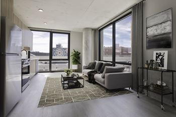 A living room with a couch and a coffee table in front of a window