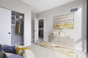 A bedroom with grey walls and a large bed