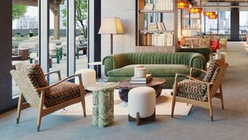 Chicago apartment for rent - A living room with a green sofa, two chairs and a table.