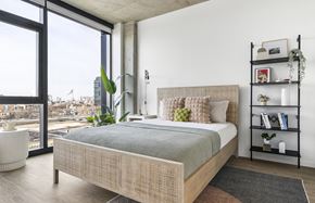 Chicago apartment for rent - a bedroom with a bed and a large window