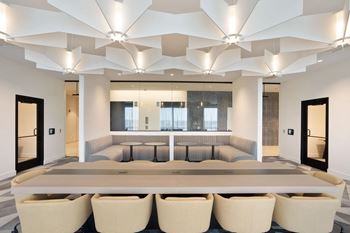 A conference room with a large table and chairs