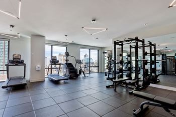 A gym with exercise equipment and a view of the city