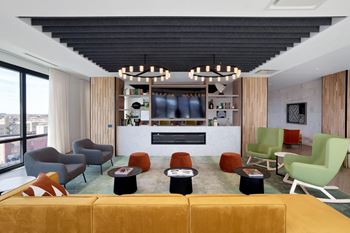 Living room with a yellow couch and colorful chairs