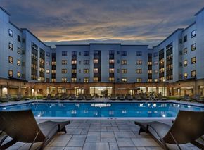 Woodbridge Township apartment for rent - a large pool with lounge chairs and a building in the background