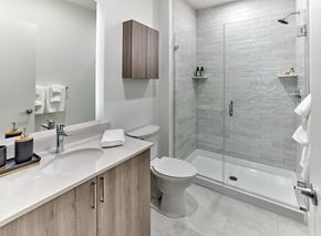 Dunellen apartment for rent - A white toilet sits in a bathroom next to a sink and a walk-in shower.