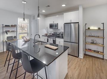 Dunellen apartment for rent - A modern kitchen with a black granite countertop and stainless steel appliances.