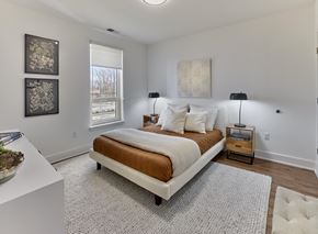 Dunellen apartment for rent - A bedroom with a bed, two lamps, and a window.