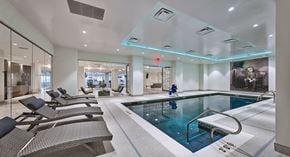 West Orange apartment for rent - a swimming pool in the middle of a room with chairs
