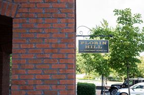 Mount Joy apartment for rent - Florin Hill Apartment Homes sign on a tree.