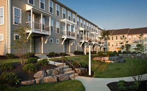 Mount Joy apartment for rent - A row of apartment buildings with a stone wall and steps leading to the front doors.