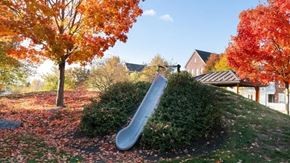 Mount Joy apartment for rent - A playground with a slide surrounded by trees with autumn leaves.