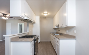 Riverside apartment for rent - A kitchen with white cabinets and a countertop.