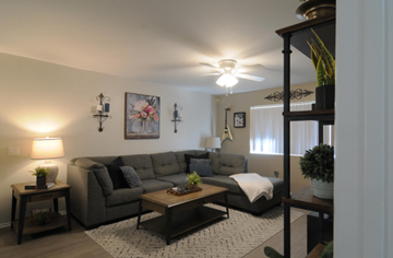 Riverside apartment for rent - A living room with a grey couch and a coffee table.