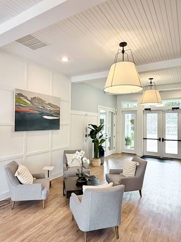 Gulf Breeze apartment for rent - A living room with a grey sofa and a painting on the wall.