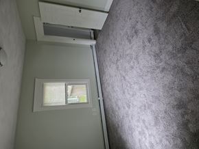 Smithfield apartment for rent - A bathroom with a window and a wall-mounted air conditioner.