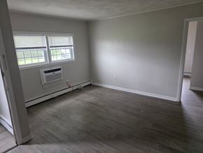Burrillville apartment for rent - A room with a window and a wall-mounted air conditioner unit.