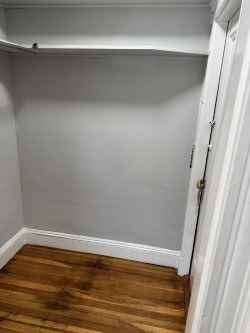 Jamaica Plain apartment for rent - A white door is open to a room with a wooden floor.