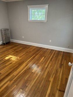 Jamaica Plain apartment for rent - A room with wooden flooring and a window.