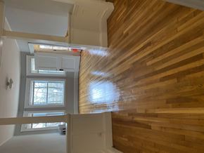 Jamaica Plain apartment for rent - A wooden staircase leads up to a second floor.
