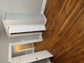 Roslindale apartment for rent - A white ventilation hood is installed in a room with wooden walls.