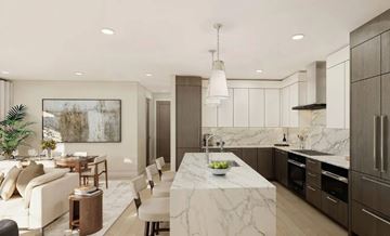 Birmingham apartment for rent - A modern kitchen with a marble countertop and a dining area with a white sofa and chairs.