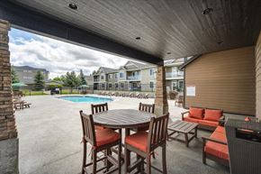 Spokane Valley apartment for rent - a patio with a table and chairs next to a pool