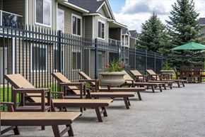 Spokane Valley apartment for rent - a row of wooden tables and chairs outside of a building