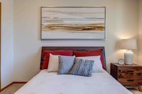 Spokane Valley apartment for rent - a bedroom with a bed and a nightstand with a lamp
