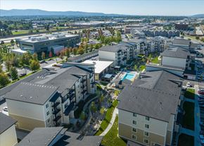 Spokane Valley apartment for rent - an aerial view of apartments in a city with a pool