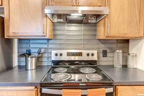 Spokane Valley apartment for rent - a kitchen with a stove top oven next to a counter