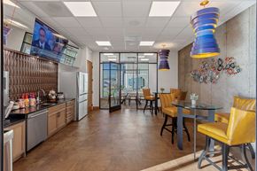 Spokane Valley apartment for rent - a dining area with a table and chairs and a television on the wall
