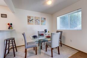 Spokane apartment for rent - a dining room with a glass table and chairs
