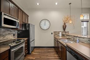 Spokane Valley apartment for rent - a kitchen with stainless steel appliances and a clock on the wall