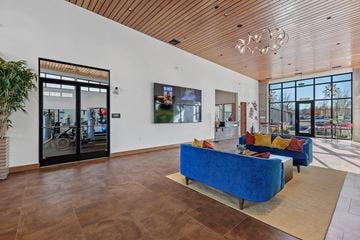 Spokane Valley apartment for rent - A living room with a blue couch and a wooden floor.