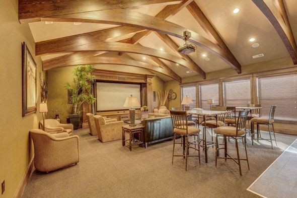 Cheney apartment for rent - A large living room with a projector screen and tables and chairs