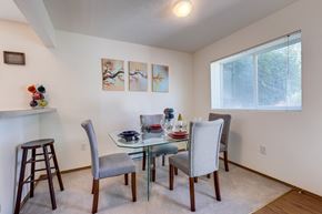 Spokane apartment for rent - a dining room with a glass table and chairs
