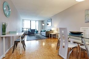 Toronto apartment for rent - a living room and dining room with a table and chairs