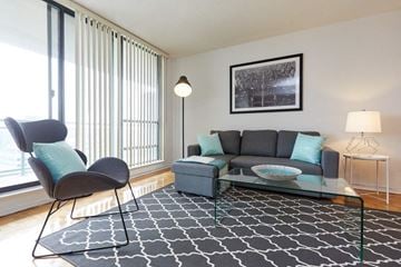 Toronto apartment for rent - a living room with a couch and a glass table