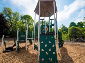 Groton apartment for rent - a playground with a swing set in a park