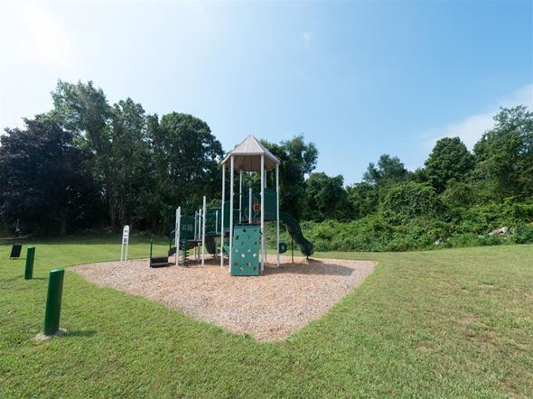 Groton apartment for rent - a playground with a swing set in a park